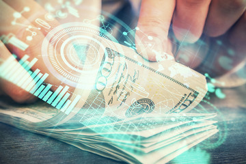 Multi exposure of financial theme drawing hologram and USA dollars bills and man hands. Business concept.