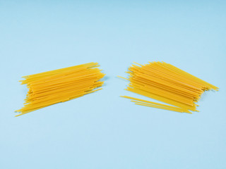 Concept of economic crisis in Italy due to Covid-19 pandemic with broken in half spaghetti on blue...