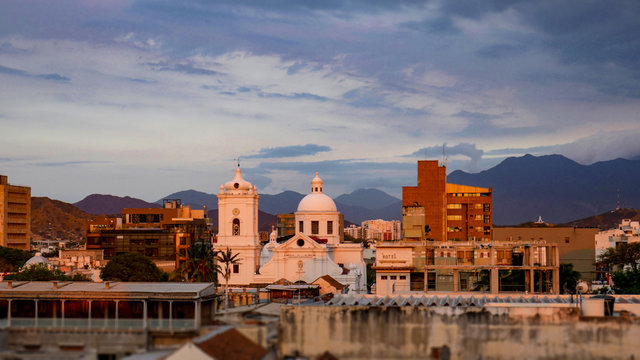 Amazing view of the city of Santa Marta, Colombia. Colonial city with church view during the sunset, warm colors, beautiful sky and mountains.