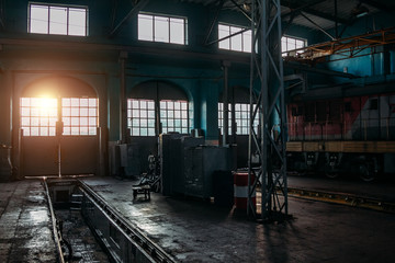 Old abandoned railroad workshop. Train repairing factory with old machinery