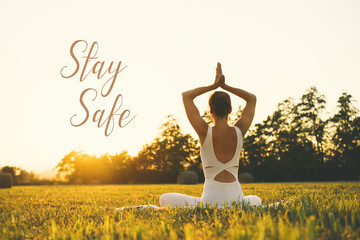 Concept image of woman doing yoga or meditation with text Stay Safe.