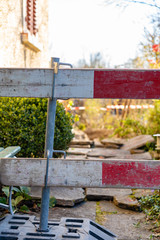 Construction barrier in front yard. Barricade for construction site of sewerage shaft. Focus on...