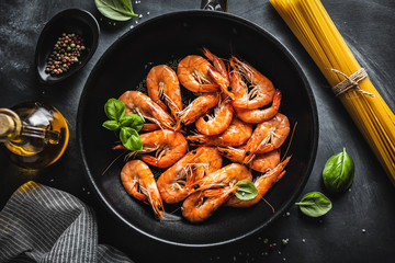 Fried shrimps with spices on pan