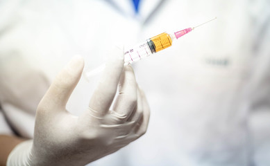 Syringe medical injection in hand holding with medicine plastic vaccination equipment with needle.