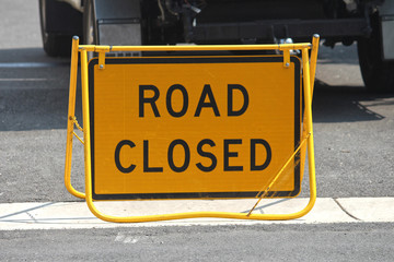 Portable fold out road closed signage. Yellow and black swing stand road sign.