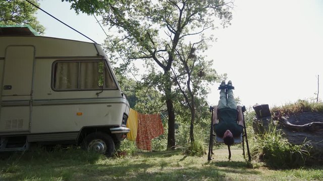 Man doing exercise on inversion table in nature to reduce back pain, relax, rest