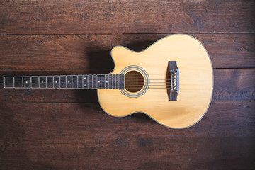 Acoustic guitar instrument on wooden background