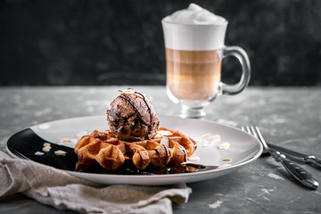 Viennese Waffles with ice cream and coffee. Beautiful picture of dessert with latte coffee. Dessert concept, sweet life. Food photo, copy space, gray background.