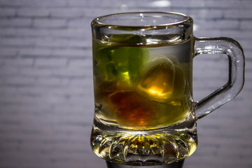 Unusual bright cocktail. Drink in a glass. The sun in the glass. Fire cocktail. Background.