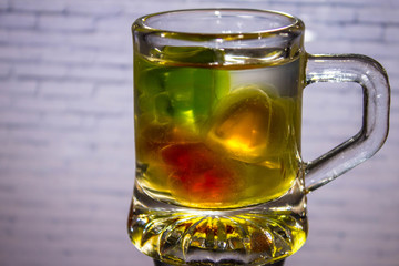 Unusual bright cocktail. Drink in a glass. The sun in the glass. Fire cocktail. Background.