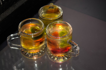 Unusual bright cocktail. Drink in a glass. The sun in the glass. Fire cocktail. Background.