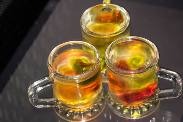 Unusual bright cocktail. Drink in a glass. The sun in the glass. Fire cocktail. Background.