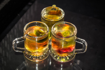 Unusual bright cocktail. Drink in a glass. The sun in the glass. Fire cocktail. Background.