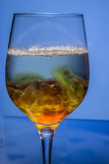 Unusual bright cocktail. Cocktail in a glass. The sun in the glass. Fire cocktail. Background.