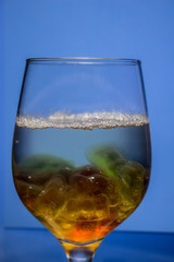 Unusual bright cocktail. Cocktail in a glass. The sun in the glass. Fire cocktail. Background.