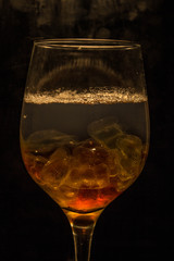 Unusual bright cocktail. Cocktail in a glass. The sun in the glass. Fire cocktail. Background.