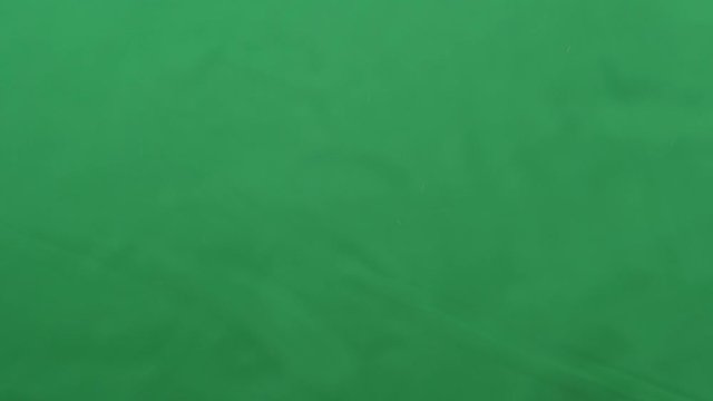 potato chips in free fall on a green background. Slow motion. Pringles