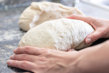 woman hands kneading homemade bread