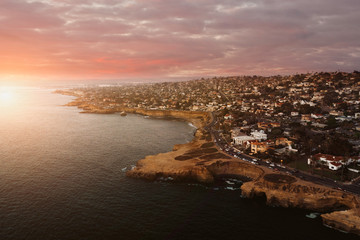 sunset or sunrise at a beach over looking cliffs