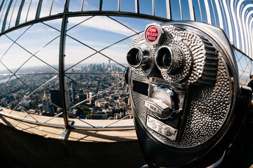 Detail of binoculars and background view of New York City from the Empire State Building. USA America, Manhattan