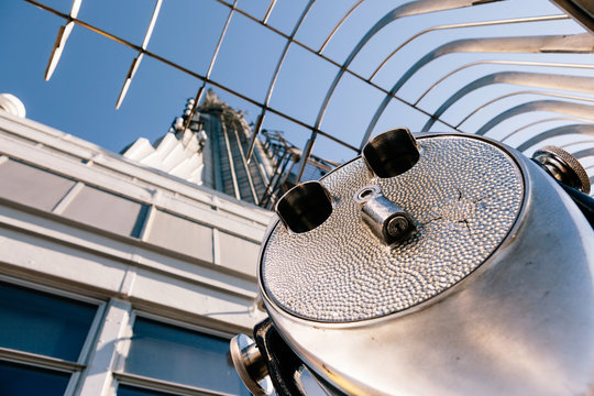Detail of binoculars and background view of New York City from the Empire State Building. USA America, Manhattan - Powered by Adobe