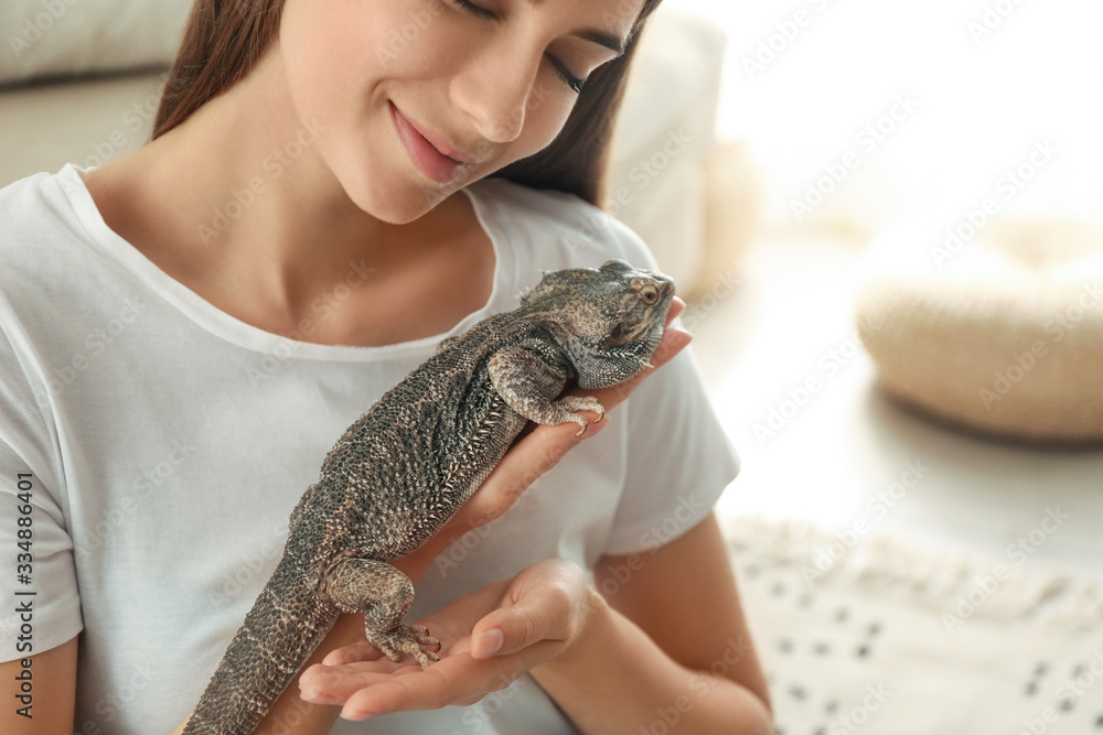 Canvas Prints Woman holding bearded lizard indoors, closeup. Exotic pet