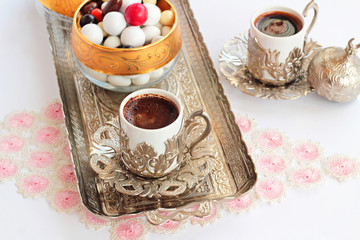 Obraz na płótnie Canvas Traditional Turkish Hard Almond Candies designed on white surface with chocolate and coffee.