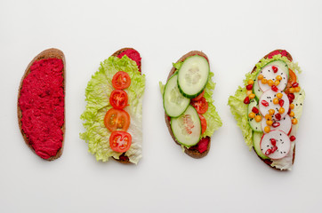 different stage of cooking open sandwich with beetroot hummus with vegetables and tomato sauce. Healthy vegan food concept.