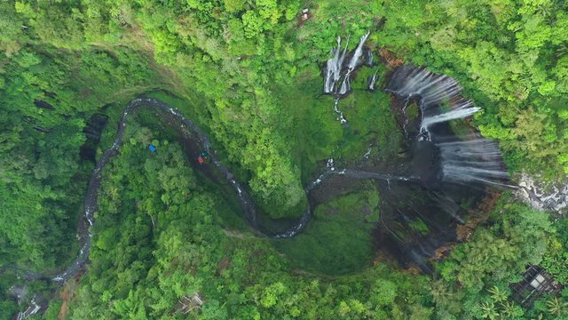 View from above, stunning aerial view of the Tumpak Sewu Waterfalls also known as Coban Sewu. Tumpak Sewu Waterfalls are a tourist attraction in East Java, Indonesia.