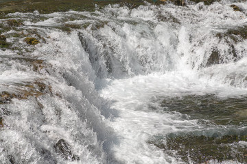 Small waterfall with clear turquoise water in Huancaya town, Lima Region, Peru