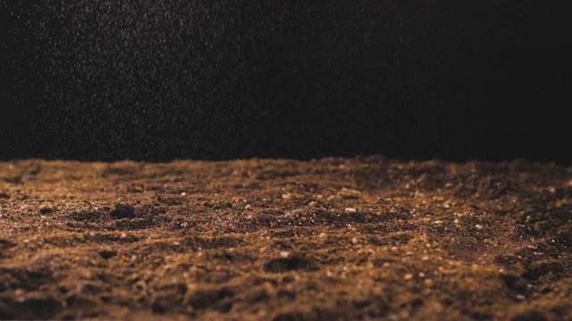 Water drops falling on soil