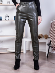 Woman wearing gray leather trousers.  - 334889827