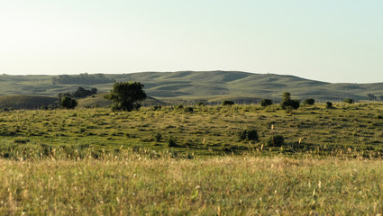 Sunset in mountain ranges in the field