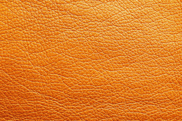 Texture of orange leather as background, closeup