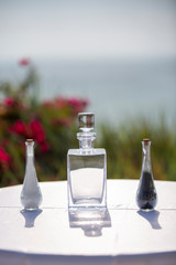 Cyrstal decanter, salt and pepper shakers on a table with white linen