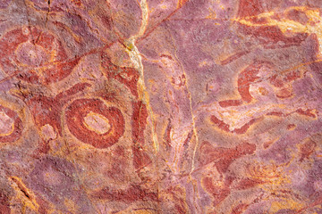 Colorful sand and sedimentary rocks, creating abstract patterns on the beach of Peroba, Icapui,...