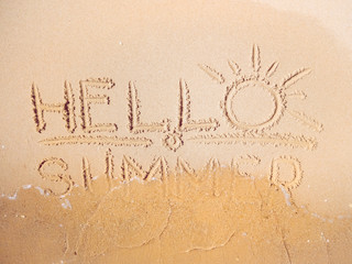 Close up view on yellow sand with inscription written by finger. Red Sea beach in February. Texture of yellow sand. Words on sand. Selective soft focus. Blurred background