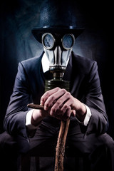 social distancing man in top hat and black suit wearing gas mask and holding a cane