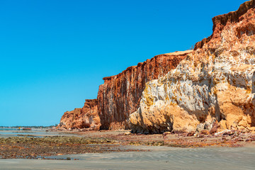 Fototapeta na wymiar Colorful sand cliffs at the paradisiacal Praia de Vila Nova, Icapui, Ceara, Brazil on September 6, 2016