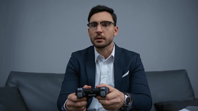 upset businessman playing video game