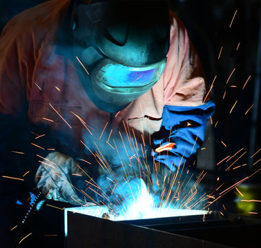 Welder At Work In Confined Space