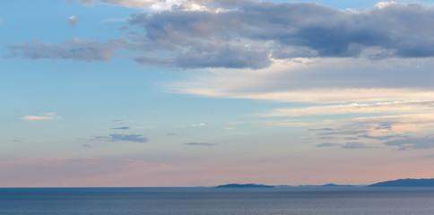 sunset over the sea, hills on the horizon