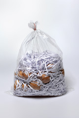 Isolated Raw eggs are in the plastic bag with waste paper on white backgroud, Supply food for...