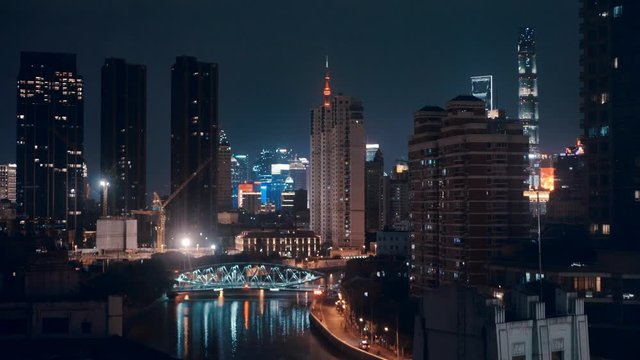Night view over Shanghai skylines with neon and reflection glowing in the dark. April 2020.