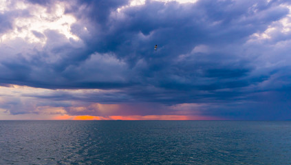 Storm sunset twilight dusk cloudscape over ocean horizon