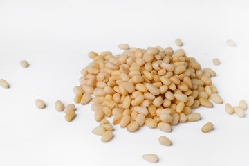 Fresh peeled cedar nuts isolated on white background, closeup