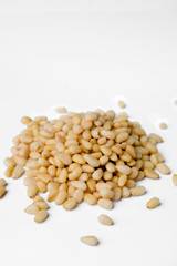 Fresh peeled cedar nuts isolated on white background, closeup