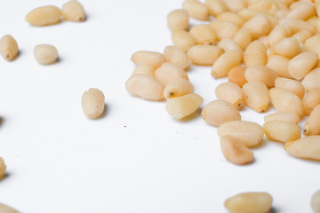 Fresh peeled cedar nuts isolated on white background, closeup