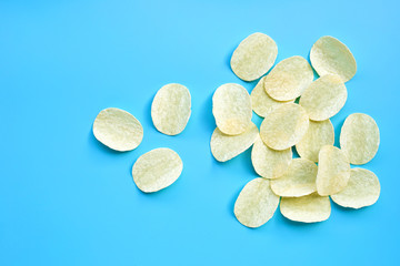 Potato chips on blue background.
