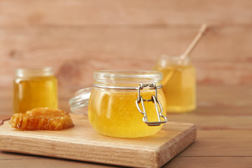 Jar of sweet honey on table